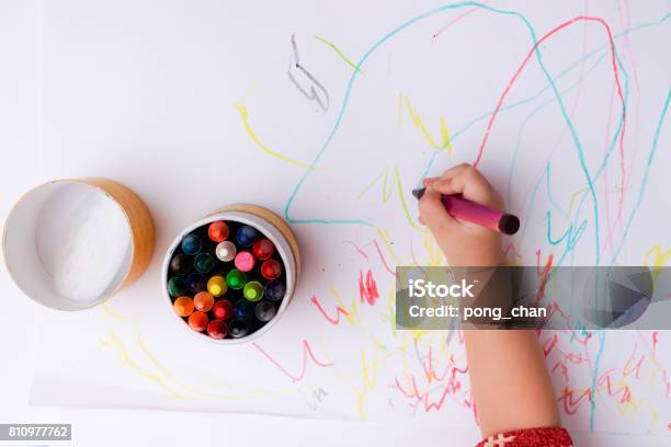 A Hand Of Baby Drawing Lines And Shapes With Colorful Crayons Stock Photo - Download Image Now