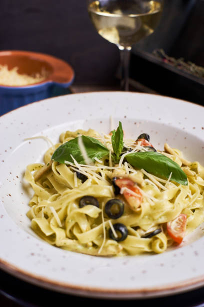 istock pasta with chicken slices and wine 810985378