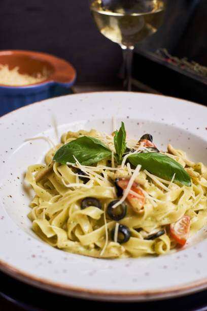 istock pasta with chicken slices and wine 810985408