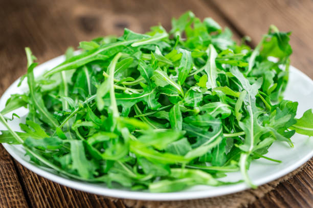 istock Fresh Arugula on an old wooden table 810990206