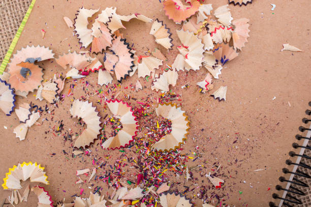 istock Colorful pencil shavings on brown background 810998162