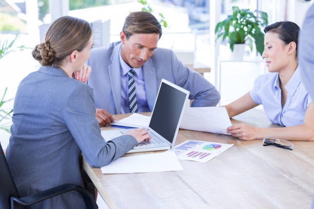istock Colleagues with laptop and digital tablet in meeting 811007164