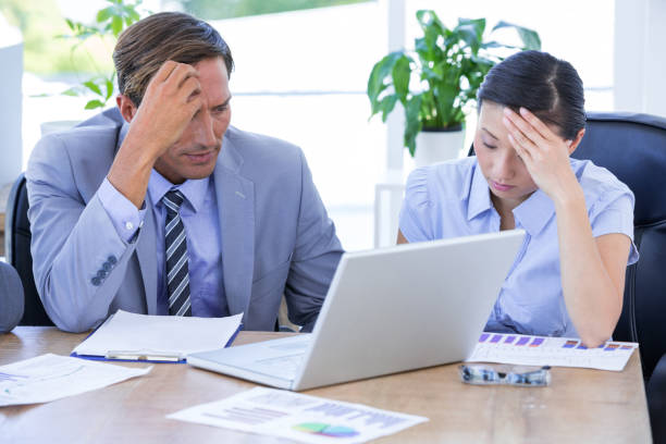 istock Colleagues with laptop and digital tablet in meeting 811007500