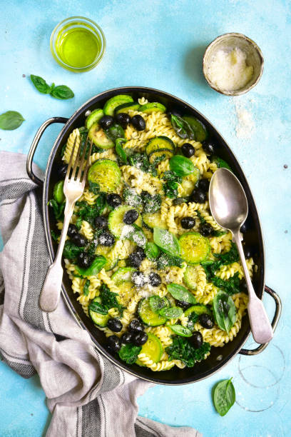 istock Summer pasta with green vegetables and black olives 811010378