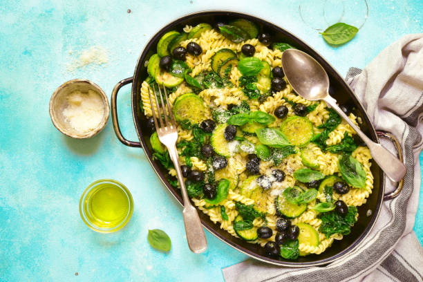 istock Summer pasta with green vegetables and black olives 811010380