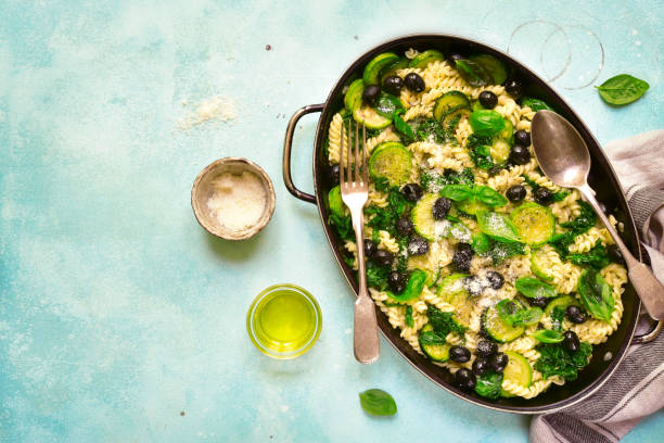 istock Summer pasta with green vegetables and black olives 811010388