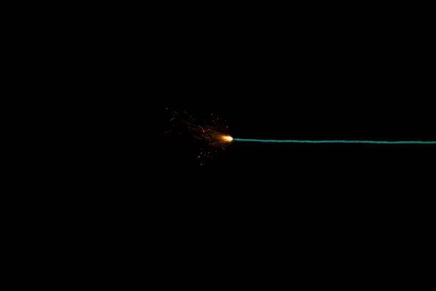 Long green fuse burning on black background isolated