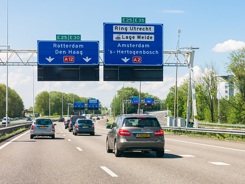 Traffic on motorway A12 and overhead route information signs, Oudenrijn, Utrecht,  Netherlands