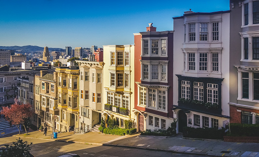 View of colorful San Francisco row homes looking down a steep city street