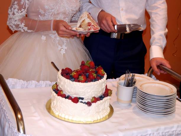 istock Bride and groom cut wedding cake 811030026