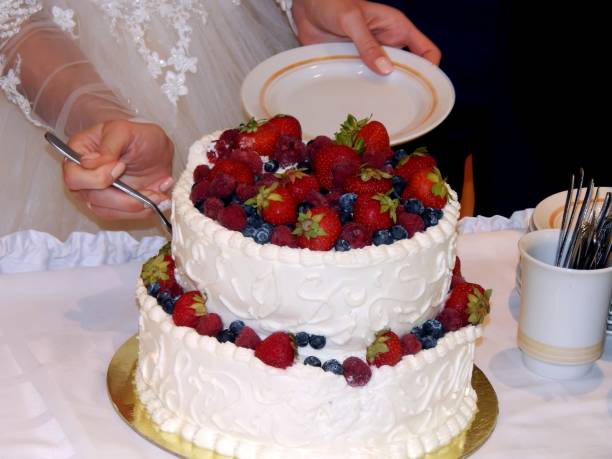 istock Bride and groom cut wedding cake 811030028