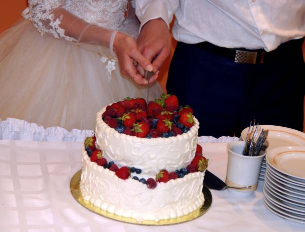 istock Bride and groom cut wedding cake 811030030