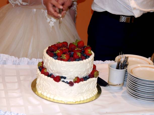 istock Bride and groom cut wedding cake 811030032