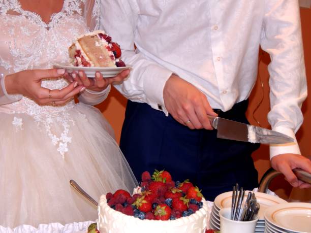 istock Bride and groom cut wedding cake 811030034