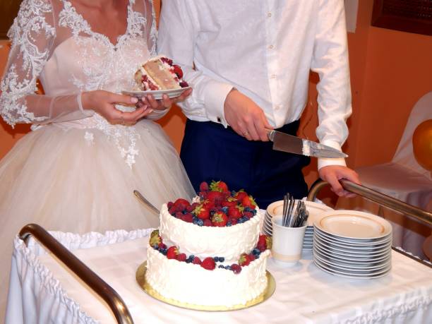 istock Bride and groom cut wedding cake 811030038