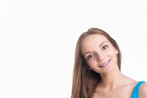 Pretty Blond Girl With Brackets on Her Teeth. Isolated Over White Background. Horizontal Image