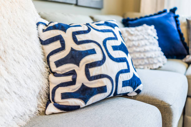 istock Closeup of new modern blue couch sofa by windows with natural light and pillows 811037196