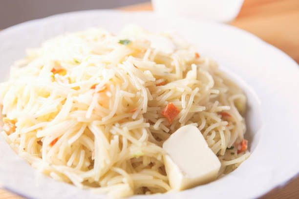Macaroni With Piece of Butter On White Plate. Horizontal Image