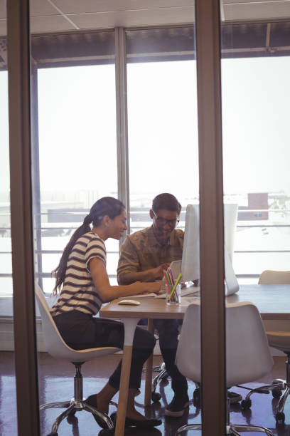 istock Businessman working with female colleague in office 811053414