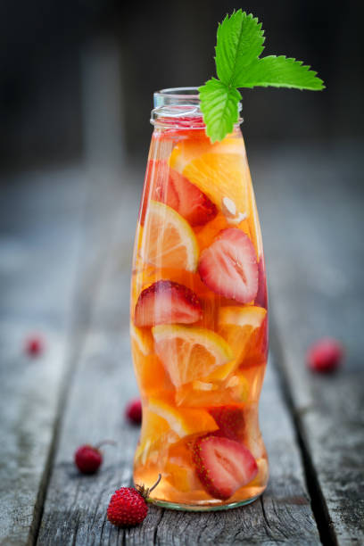 istock Fresh fruit detox water in bottle on wooden table 811055838