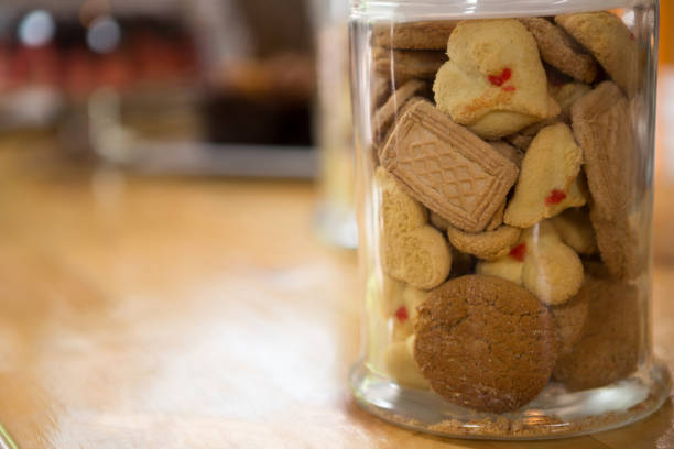 Variety of cookies in jar on counter at coffee shop