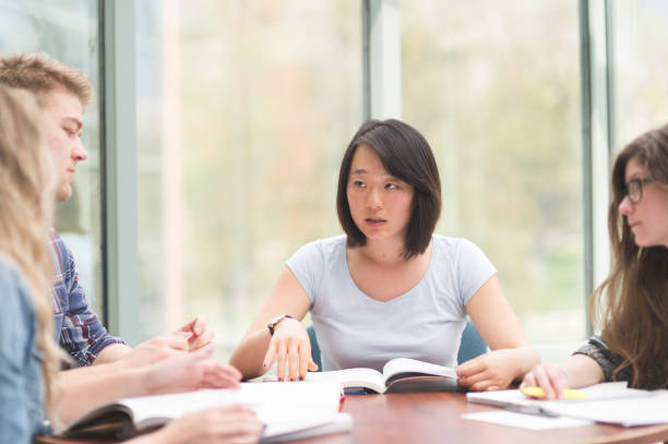 istock Multi-ethnic group of college students studying in conference room 811103444