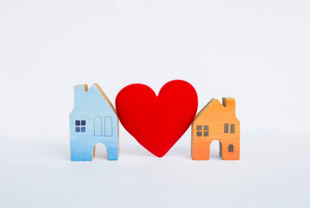 istock Wooden miniature house with red heart isolate on white background 811111406