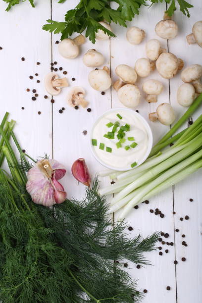 istock Still life with onions and champignons on a white wooden background 811111780