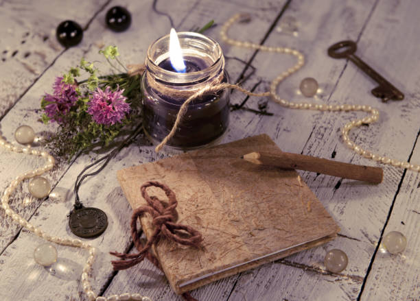 istock Black candle with diary, medallion, key and mystic objects 811119356