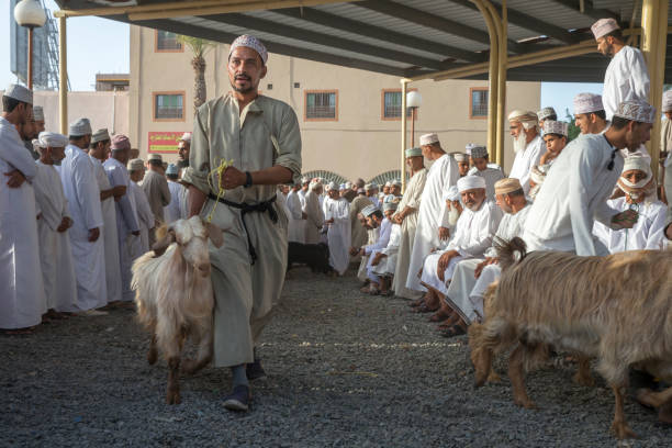 człowiek chodzenie z kozą na targu kozy nizwa - nizwa zdjęcia i obrazy z banku zdjęć