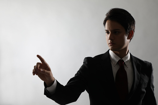 young businessman pointing in the air