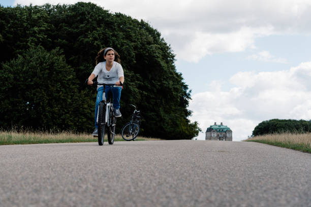 istock Pretty young woman riding bike 811146322