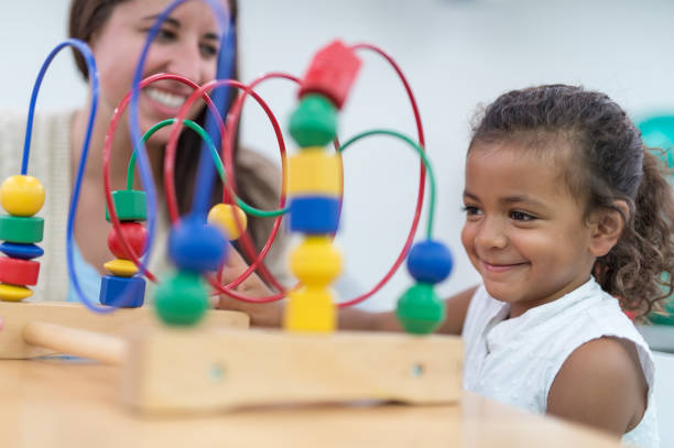 istock Therapist doing play therapy with young girl 811146410