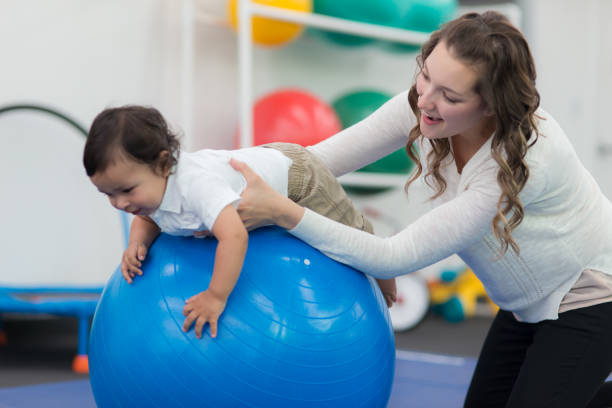 istock Exercising kids in physical therapy clinic 811146460