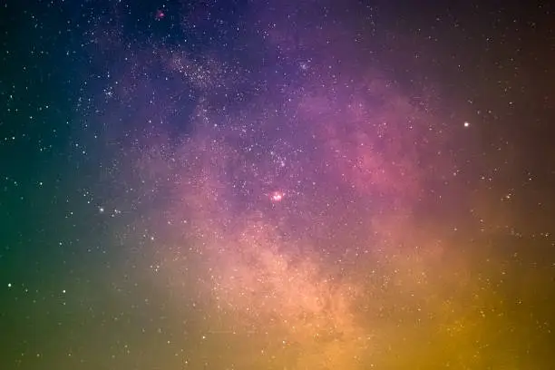 The planet Saturn in front of the Galactic Center with the Lagoon Nebula, the Trifid Nebula, and the Omega Nebula as seen from Mannheim in Germany.