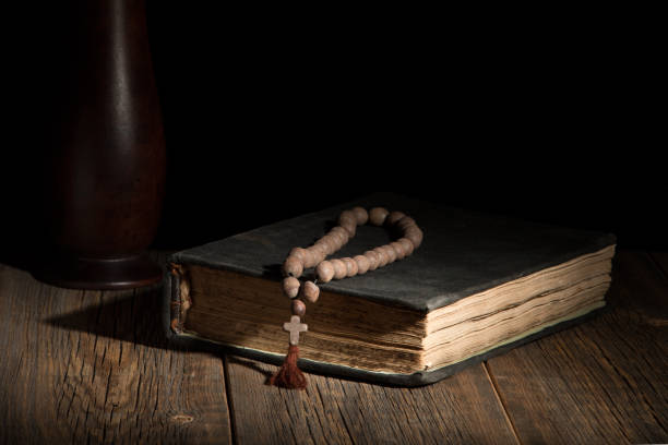 istock An old sacred book and a rosary on a wooden table 811157456