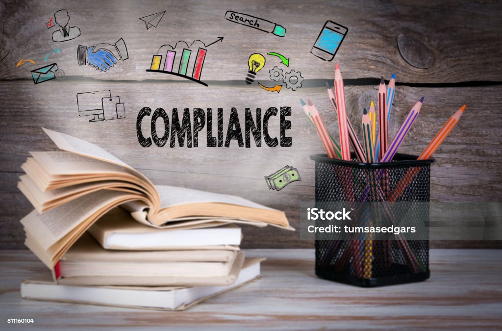 Compliance, Business Concept. Stack of books and pencils on the wooden table. Agreement Stock Photo