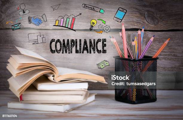 Compliance Business Concept Stack Of Books And Pencils On The Wooden Table Stock Photo - Download Image Now