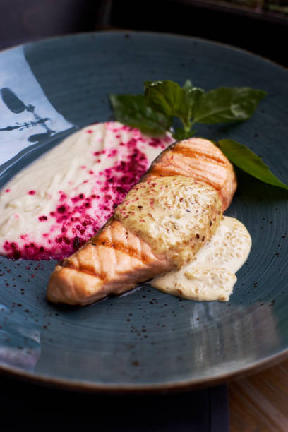 istock Grilled salmon steak on blue plate 811168772