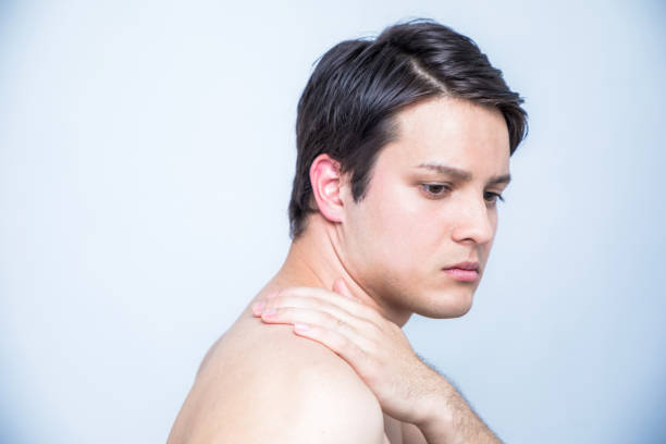 istock young man having a pain in his neck 811171482