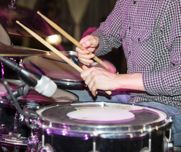 istock Musician plays drums in a rock band 811176820