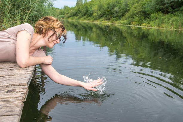 istock Beautiful young woman enjoying her weekend by the river 811179814