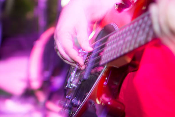 istock Musician playing guitar in a rock band 811183530