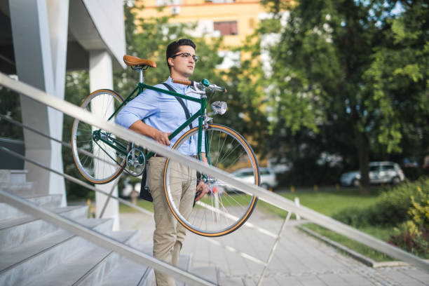 istock Handsome young businessman carrying bicycle 811192158