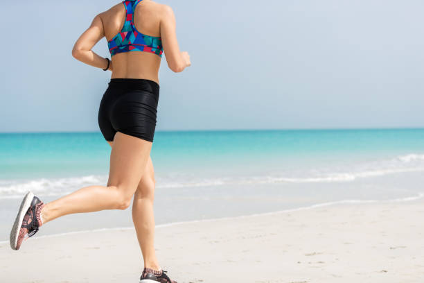 istock Woman running along sea 811194862