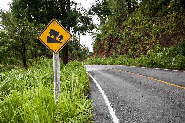 the street sign down hill warning on the mountain road - highway street road speed imagens e fotografias de stock