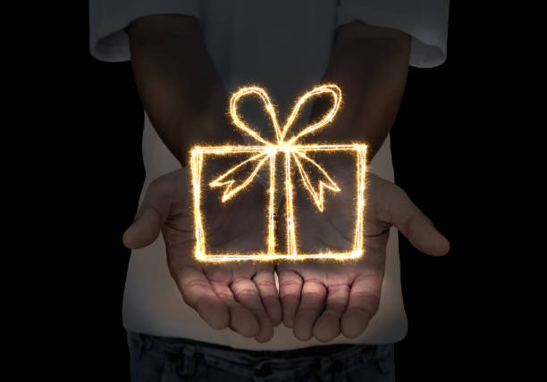 istock Gift box sign from sparkler in open hands 811211062