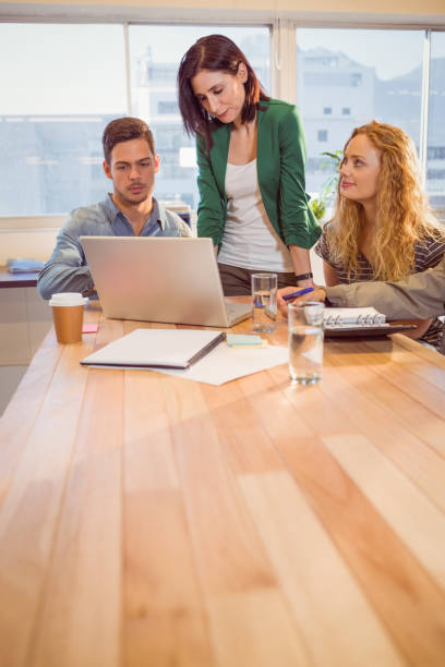 istock Group of young colleagues using laptop 811214388