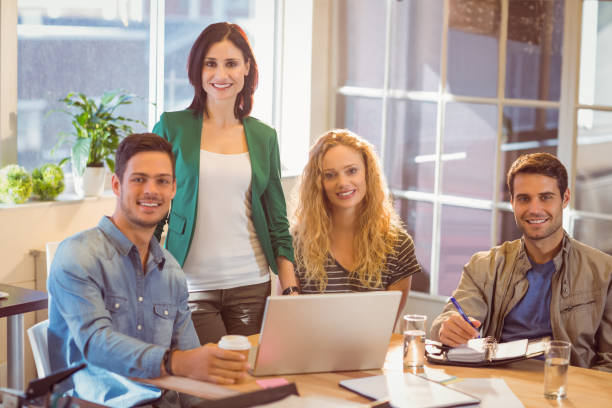istock Group of young colleagues using laptop 811214826