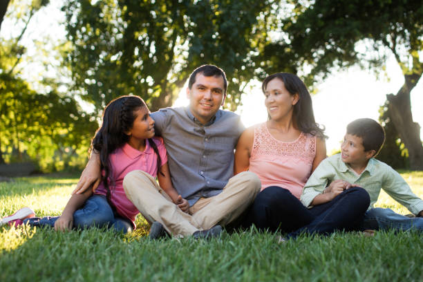 istock Loving family sitting outdoors and looking at father 811215902